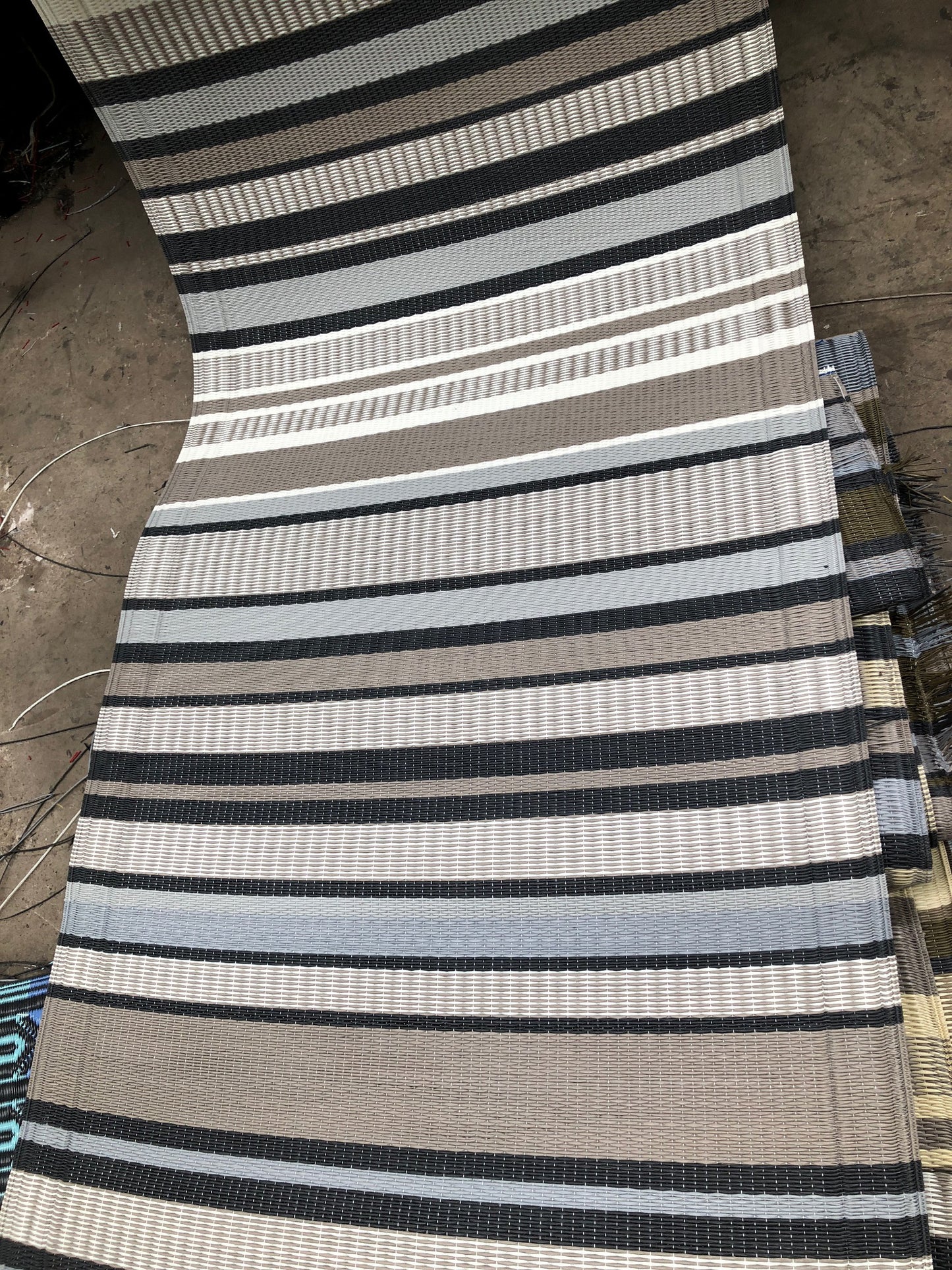 This is the 2.5'x8' Runner in Cool Grey coming off of the loom in Thailand. 